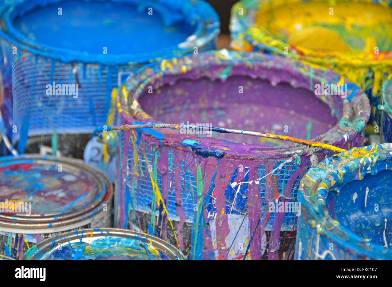 Colorful dripping paint on sides of paint cans Stock Photo Alamy