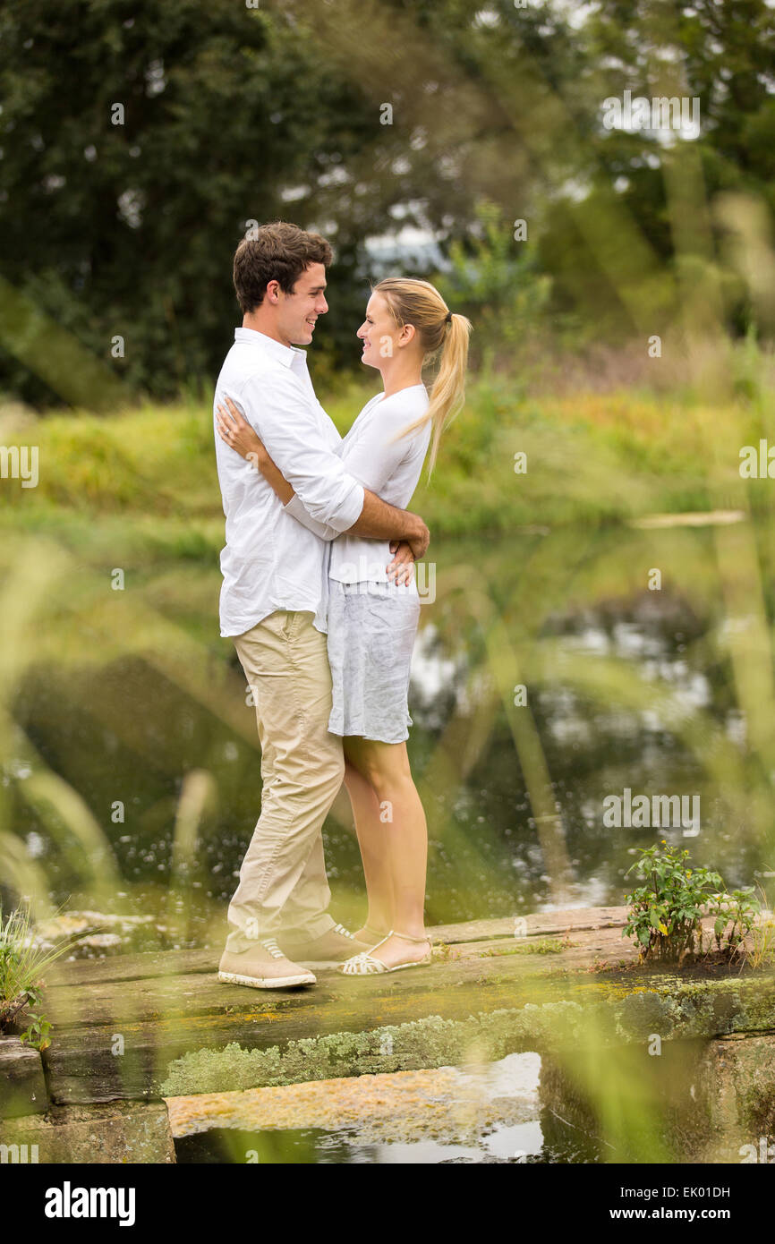 beautiful couple hugging on lake pier Stock Photo - Alamy