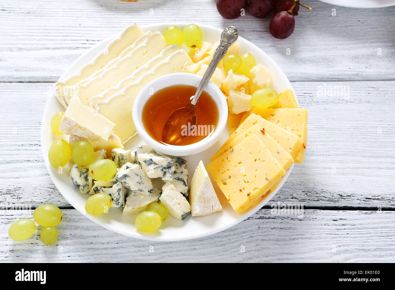 Cheeses with honey and grapes, food closeup Stock Photo Alamy