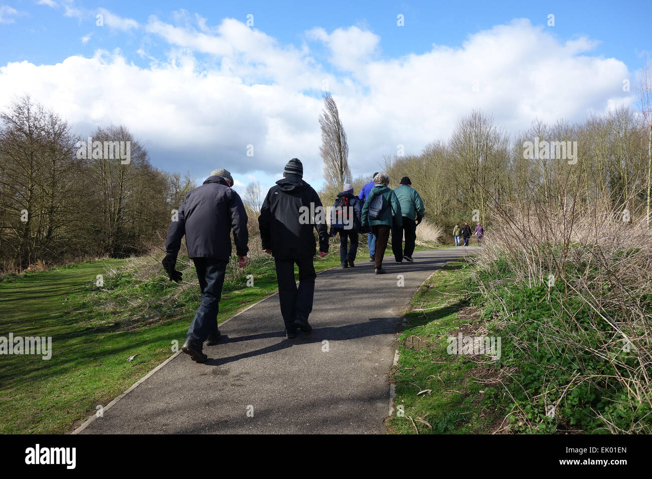 Group of retired people out on a weekly walk through local park and Riverwalk in Witham, Essex, England Stock Photo