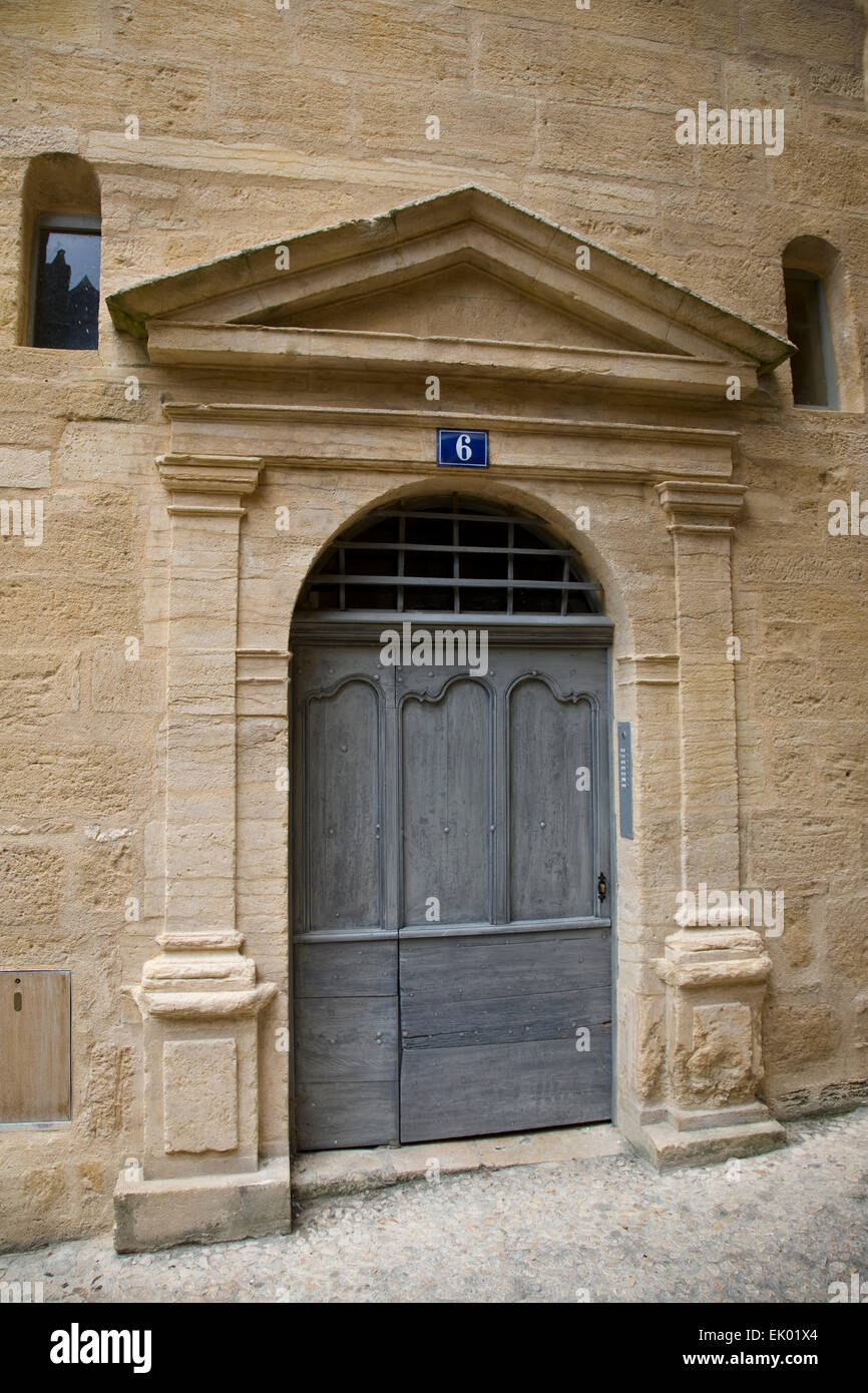 Classical style carved doorway surround with columns and portico on a house in Sarlat, Dordogne. Stock Photo