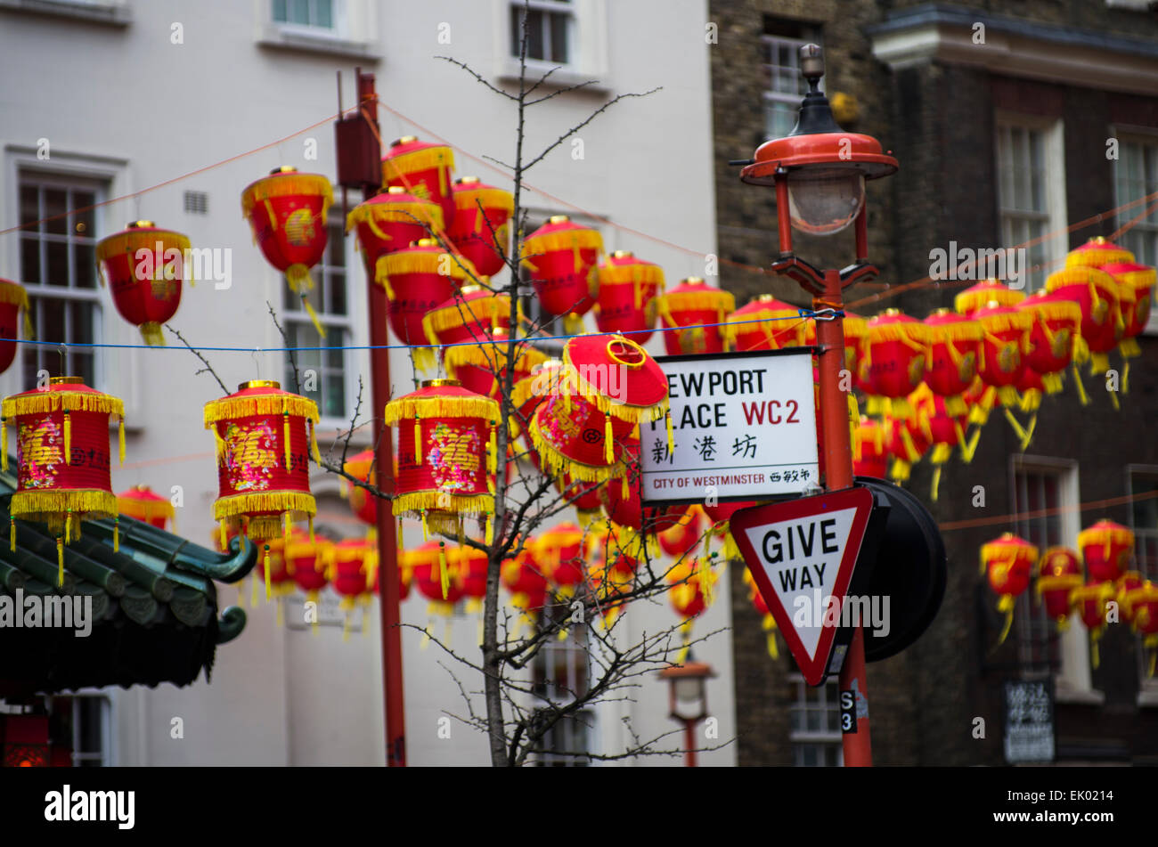 Chinese new year celebration in Chinatown in London, England. Colourful lanterns line the streets, crowds of people attending Stock Photo