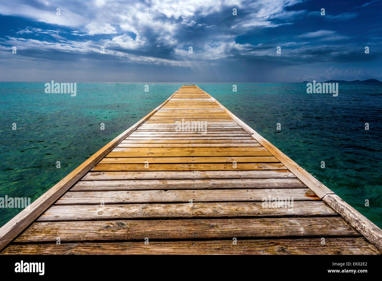 Empty Wooden Dock Over Tropical Blue Water Stock Photo