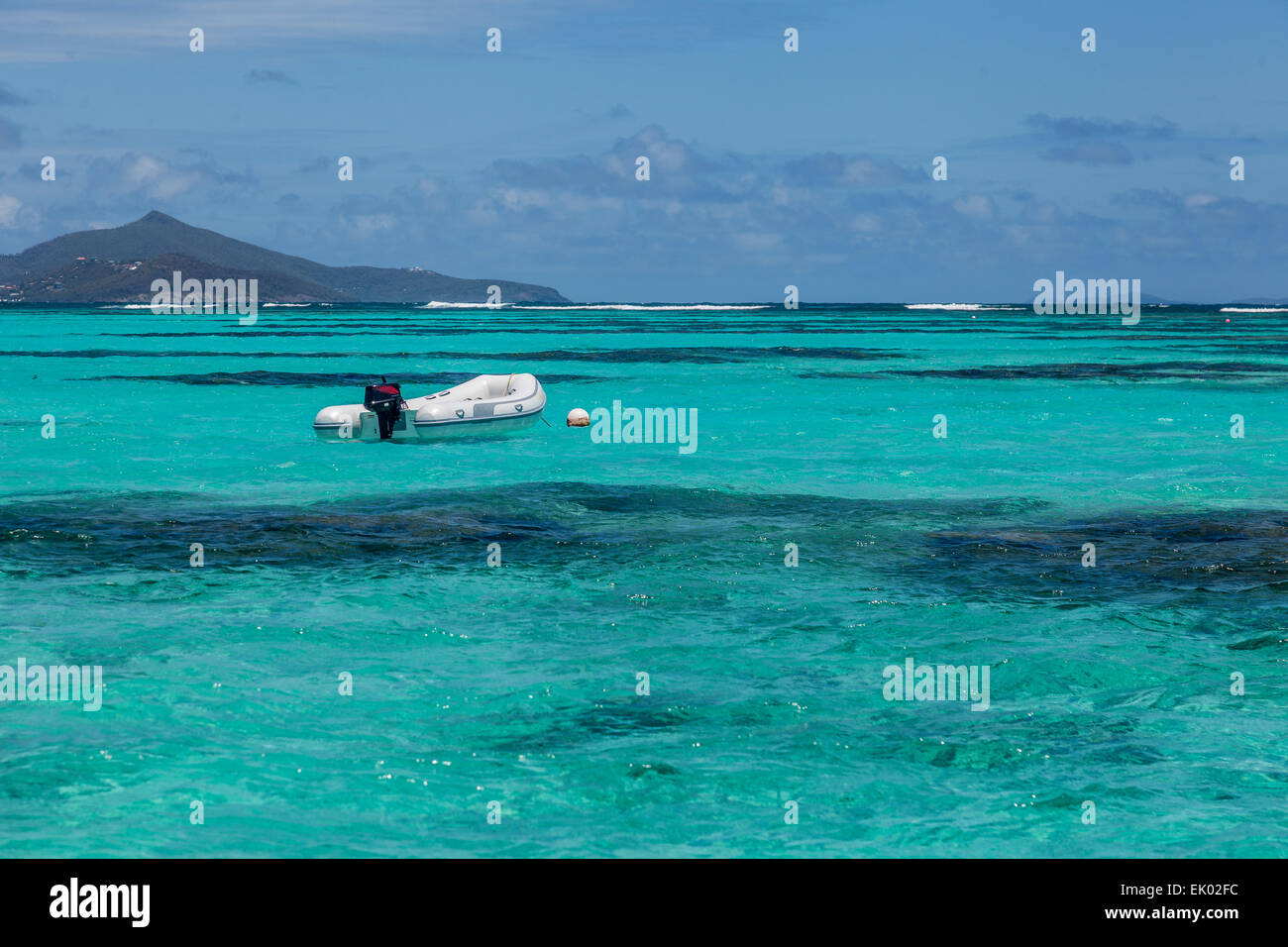 An empty dinghy on tropical water. Stock Photo