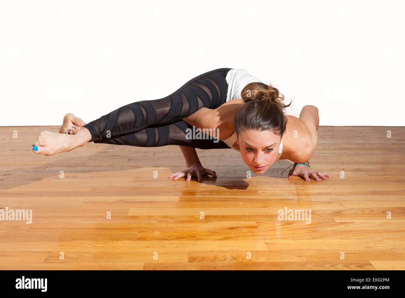 Female Yoga Astavakrasana Eight Angle Pose Stock Photo