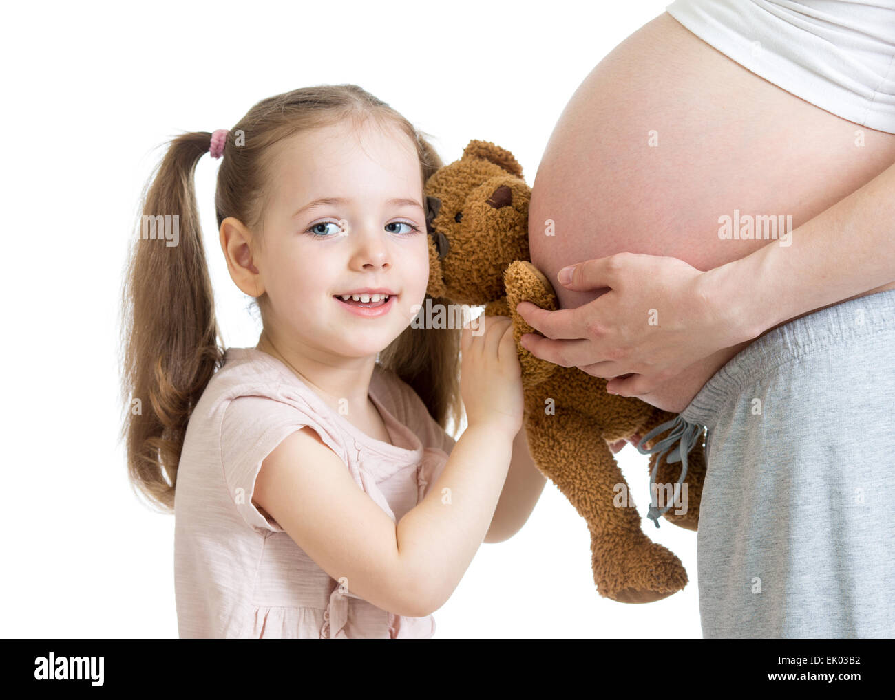 happy kid girl playing with pregnant mother Stock Photo