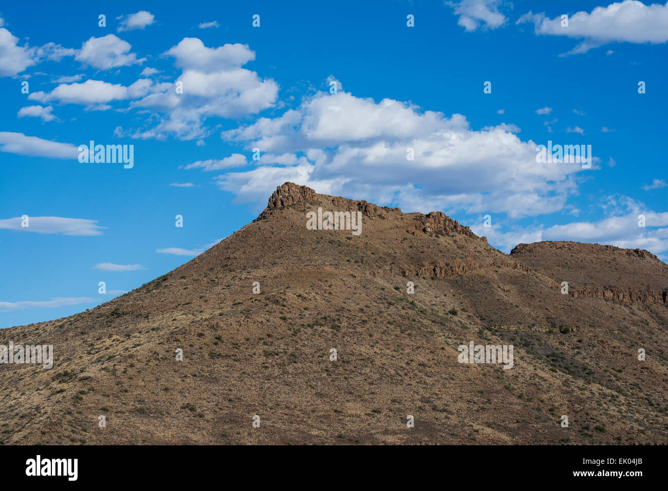 Scenic landscape of a Karoo koppie against a blue, cloudy sky Stock Photo