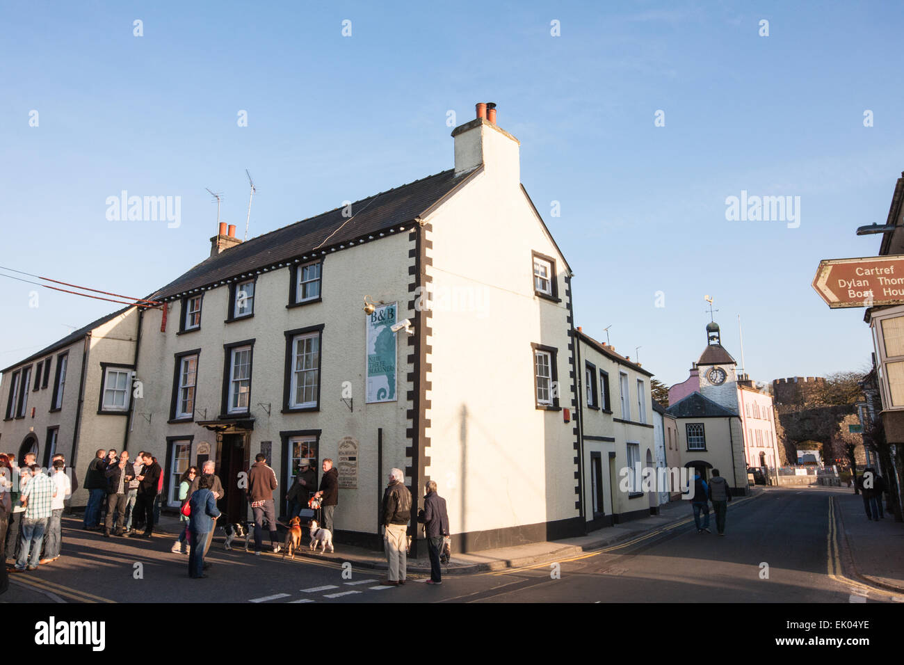 The New Three Mariners pub in centre of Laugharne with drinkers outside