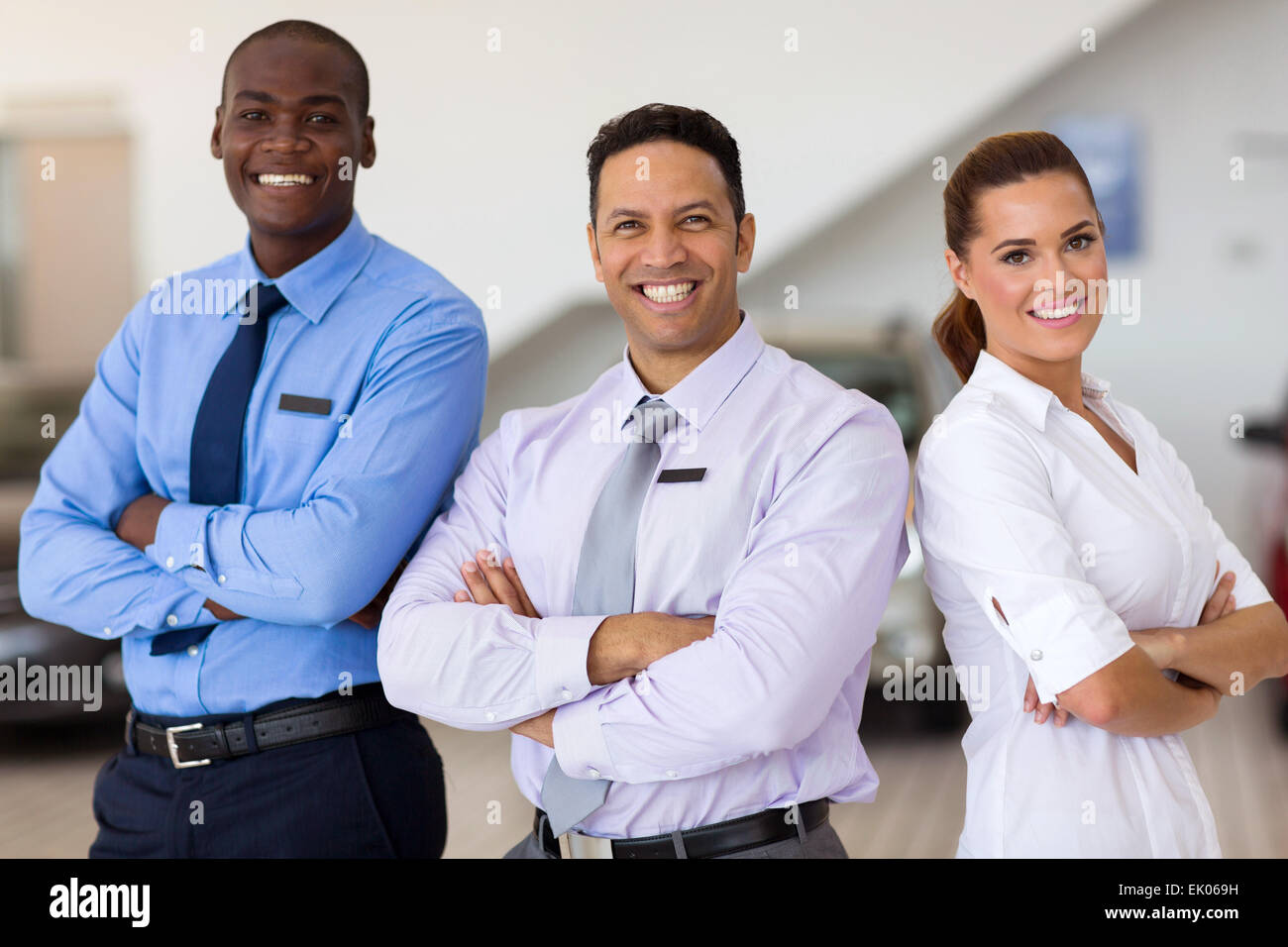 car sales staff standing inside showroom Stock Photo Alamy