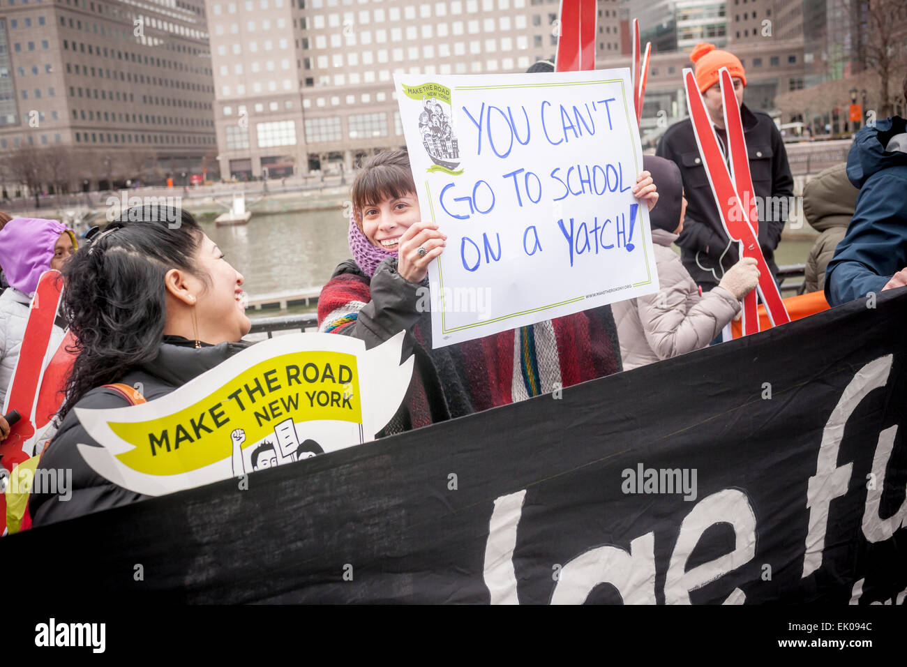 A coalition of community groups protests at the North Cove Marina in Battery Park on Tuesday, March 31, 2015 against the tax breaks written into the New York State budget for buyers of luxury yachts and private airplanes. Buyers of yachts would only pay tax on the first $230,000, topping off at $9200, of the cost no matter how expensive the yacht was. If you buy a plane you pay no sales tax at all if it carries fewer than 20 people.  (© Richard B. Levine) Stock Photo