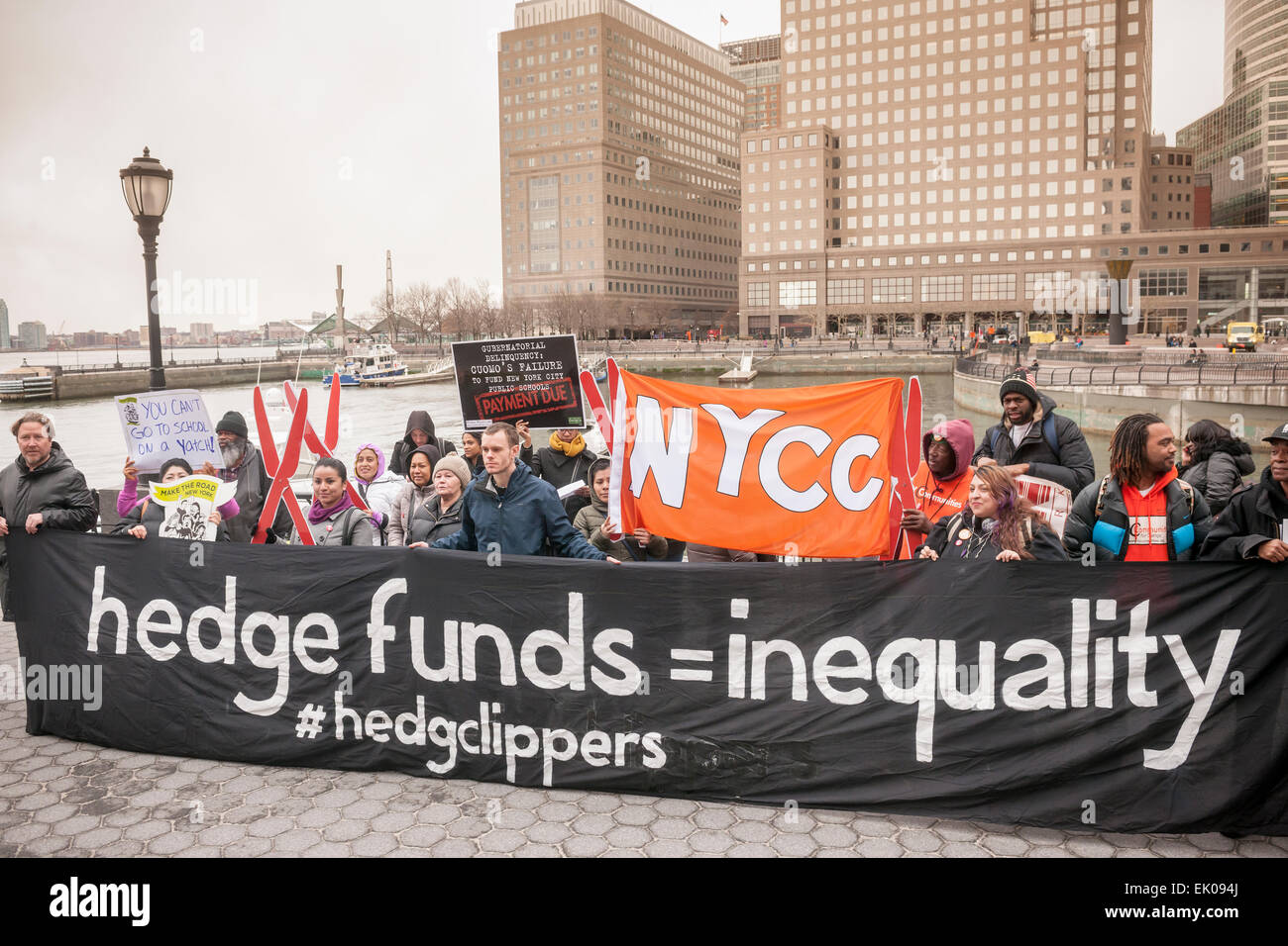 A coalition of community groups protests at the North Cove Marina in Battery Park on Tuesday, March 31, 2015 against the tax breaks written into the New York State budget for buyers of luxury yachts and private airplanes. Buyers of yachts would only pay tax on the first $230,000, topping off at $9200, of the cost no matter how expensive the yacht was. If you buy a plane you pay no sales tax at all if it carries fewer than 20 people.  (© Richard B. Levine) Stock Photo