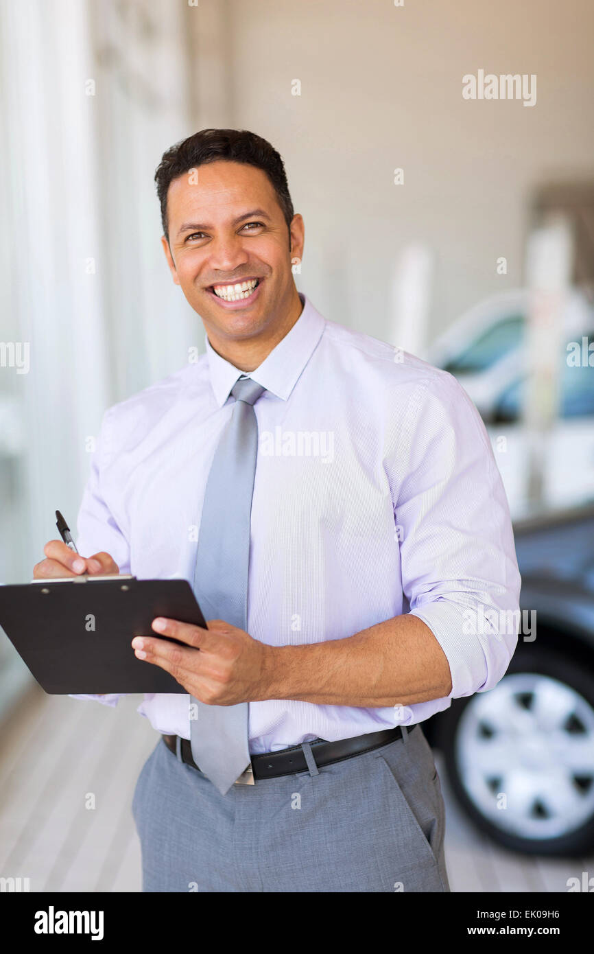 handsome car dealership salesman working in showroom Stock Photo Alamy