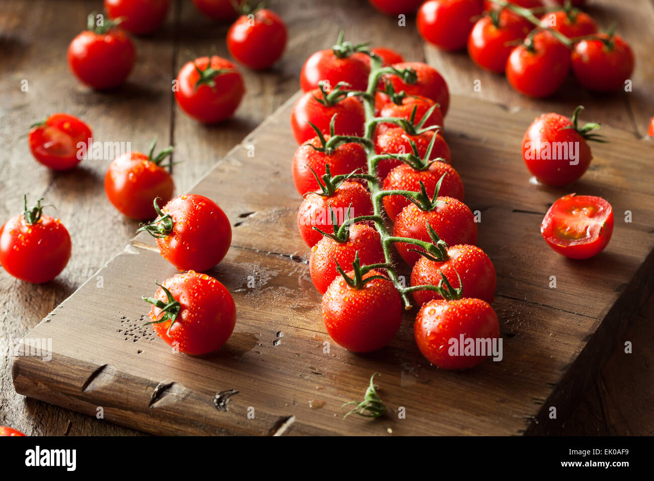 Raw Organic Red Cherry Tomatoes on the Vine Stock Photo - Alamy