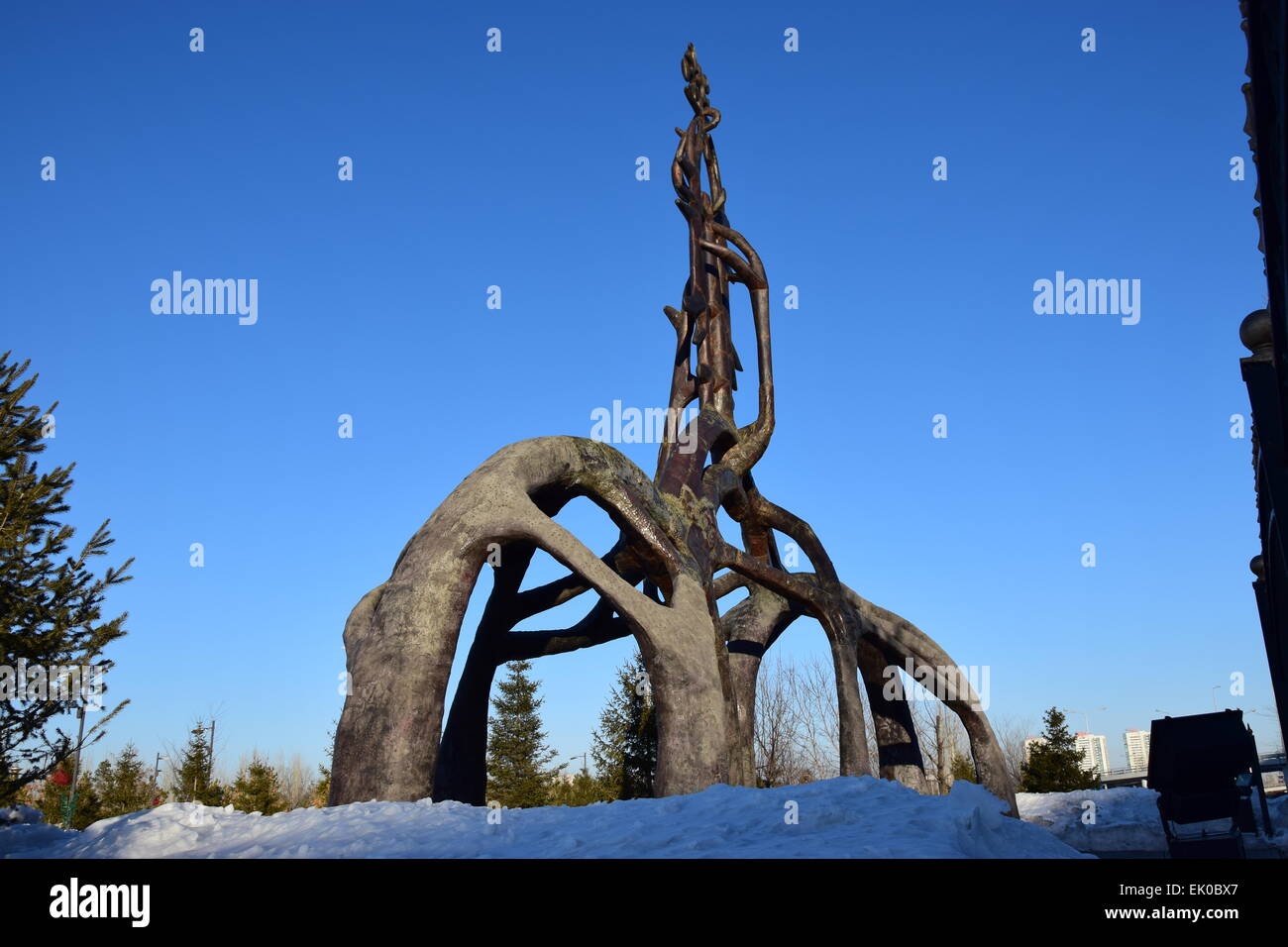 A metal monument in abstract style used as a gate to a park area in ...