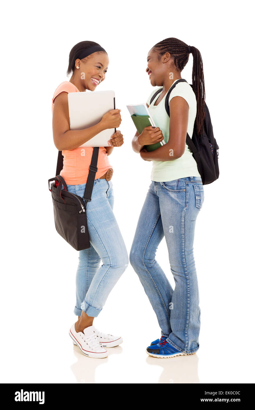 cheerful young female African college students having conversation on white background Stock Photo