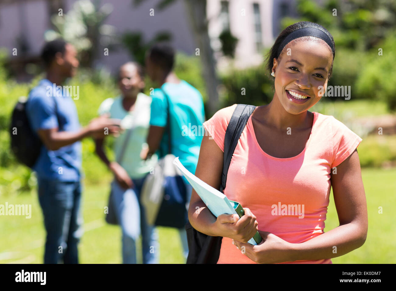 happy young African American college girl holding books Stock Photo - Alamy