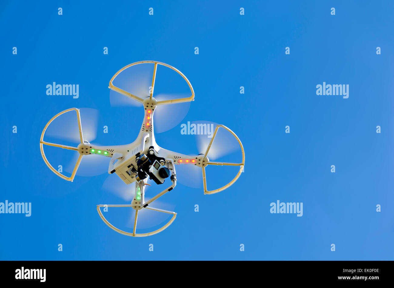 hovering white drone in sky Stock Photo