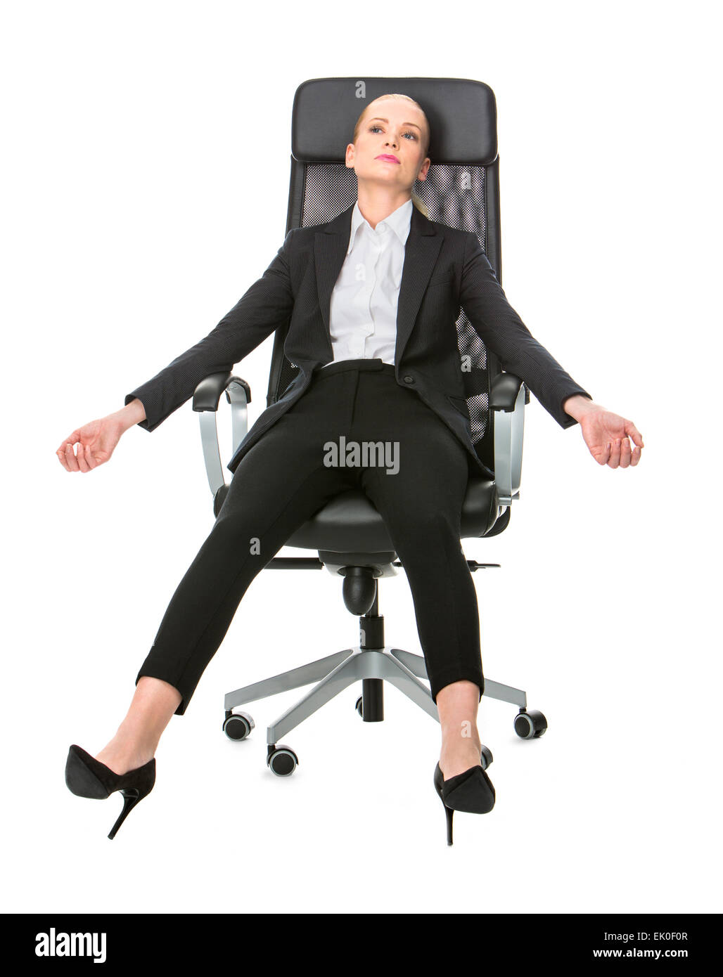 blonde businesswoman exhausted relaxing on a chair with stretched out arms Stock Photo
