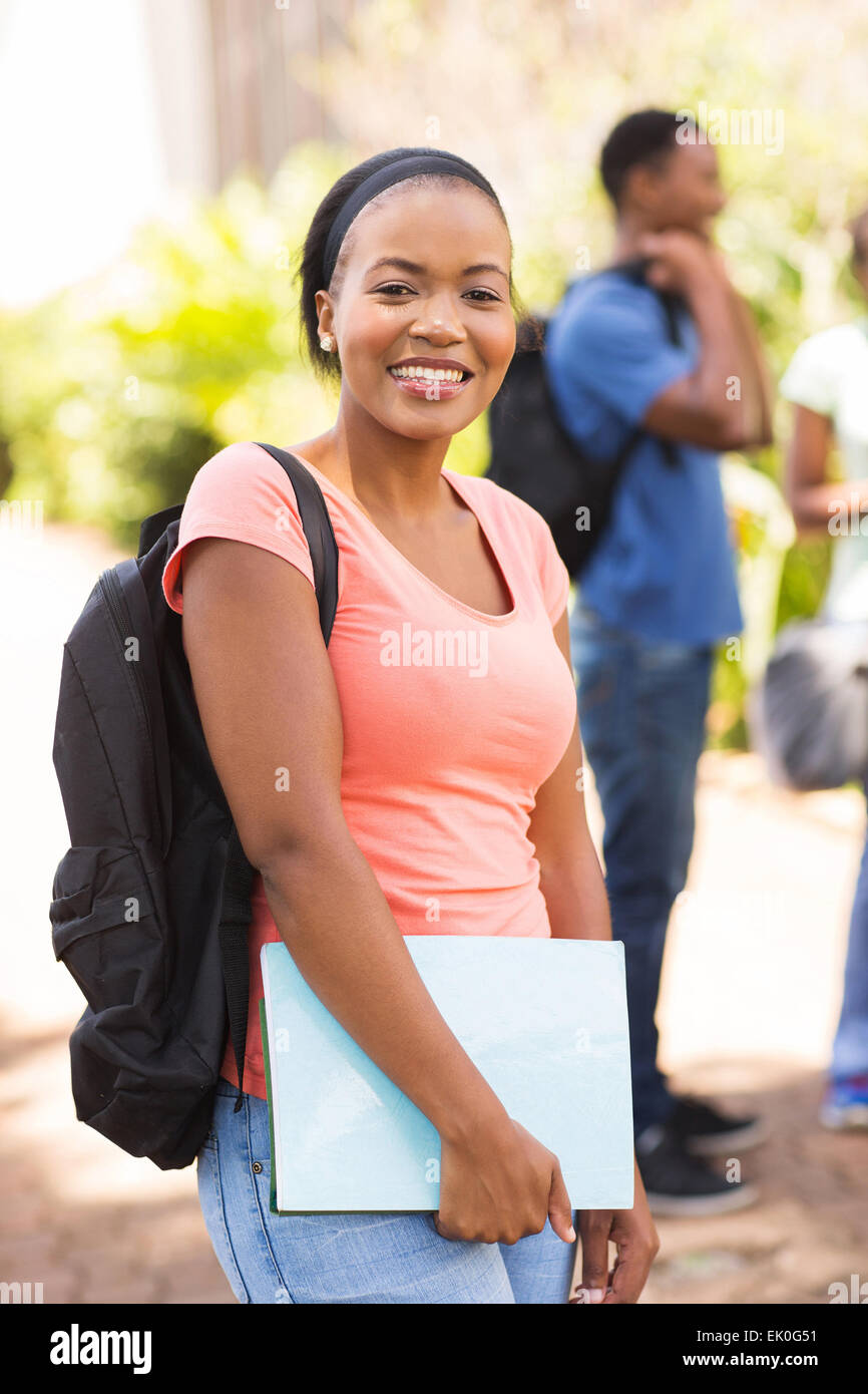 pretty female African college student with backpack on campus Stock