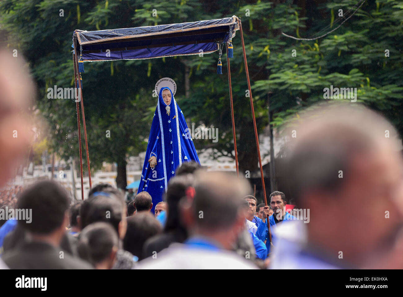 Larantuka, Indonesia. 3rd April, 2015. People march to haul an old Mother Mary statue to Cathedral Church of Larantuka, Flores Island, Indonesia. Thousands of people, including those from other cities and countries, attend a whole week ceremonies to celebrate Holy Week in the small town of Larantuka, one of the most influential cities in Indonesia in terms of Roman Catholic traditions. Strongly influenced by the Portuguese since the 16 century, Catholic rituals in Larantuka have grown in smooth acculturation with local cultures. Stock Photo