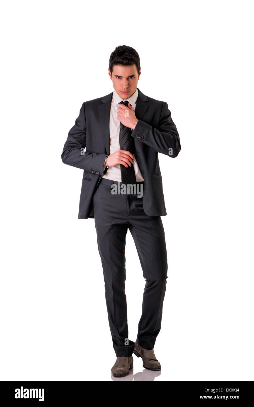 Full figure shot of handsome elegant young man with suit and neck-tie, isolated on white, looking at camera Stock Photo