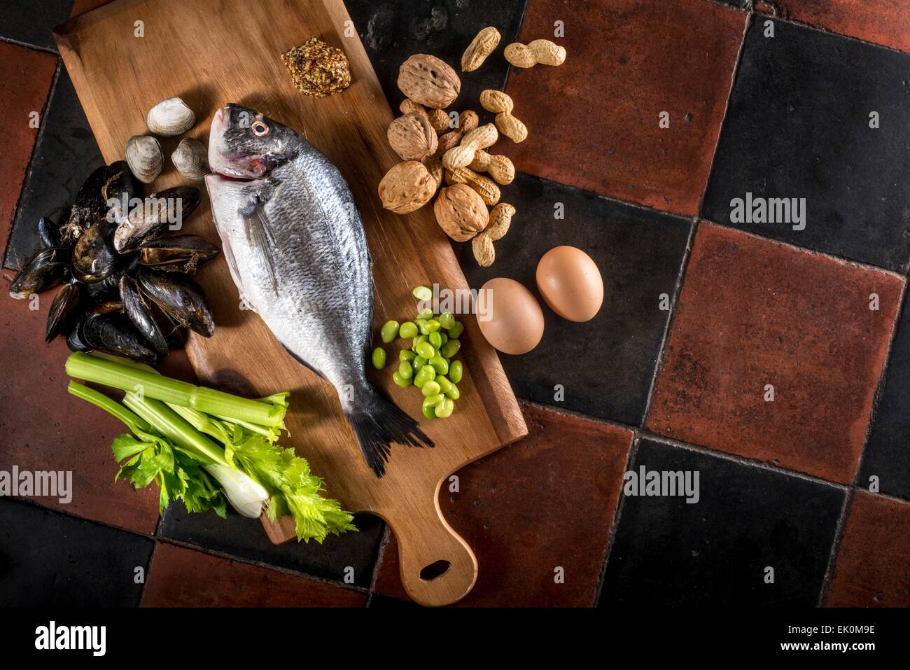 beans, celery, chopping board, crab, eggs, fish, food, food and drink, food preparation, fresh, health, healthy eating, high angle, high angle view, legumes, no one, no-one, nobody, nutrition, nuts, produce, raw, seafood, shellfish, still life, studio sho Stock Photo