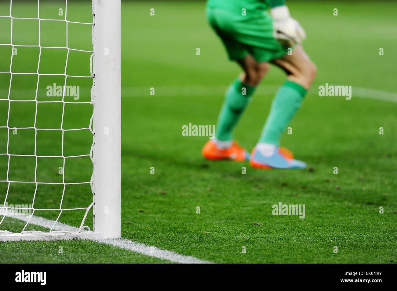 Soccer goal detail with goalkeeper preparing for a penalty kick in the background Stock Photo