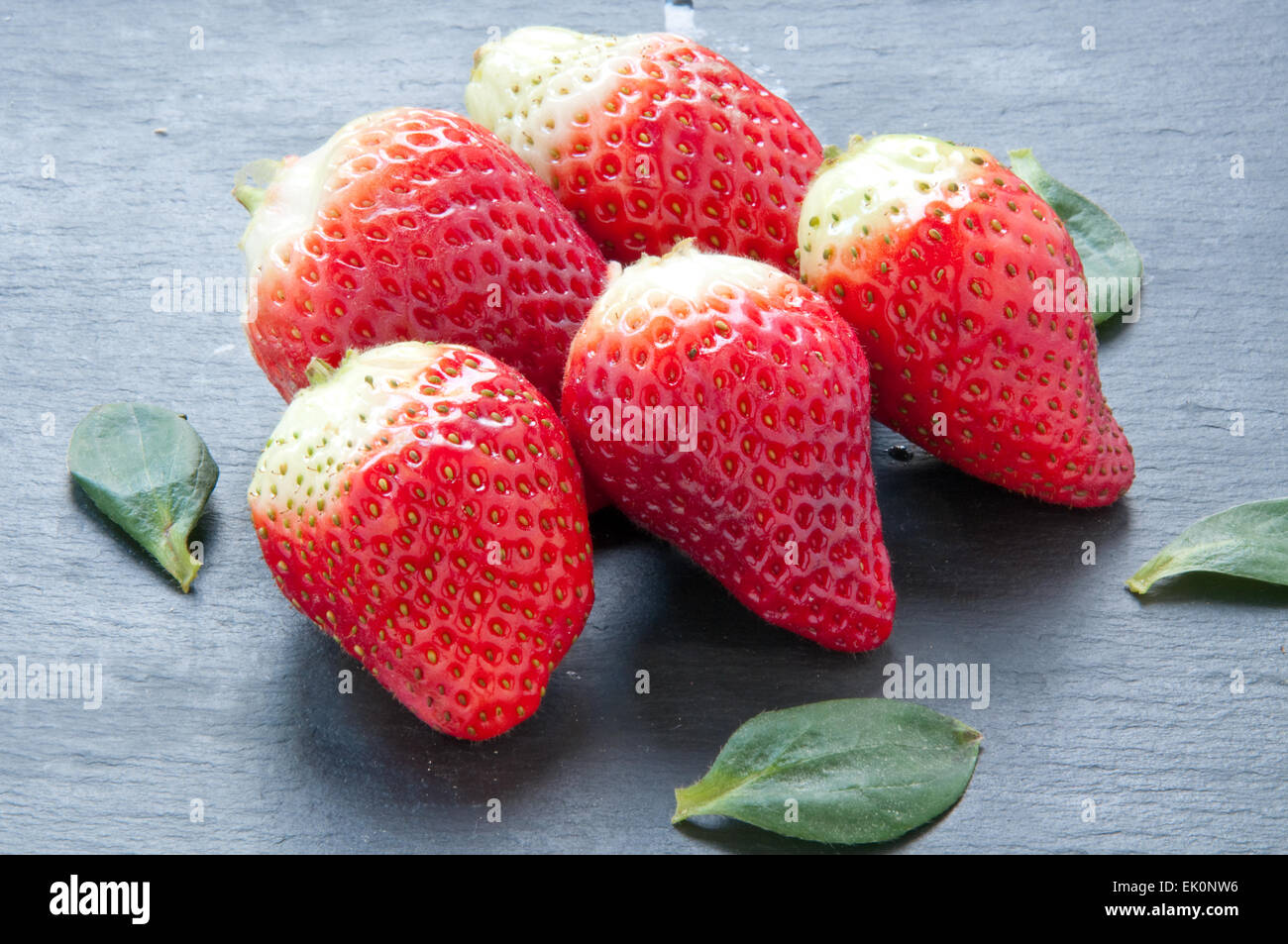 A group of red tasty fresh strawberries in season Stock Photo