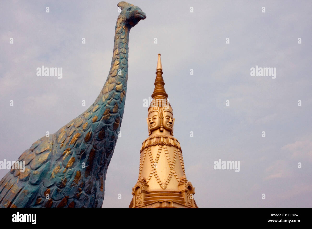 A golden stupa and a peacock sculpture are on display at a temple in Kampong Cham, Cambodia. Stock Photo