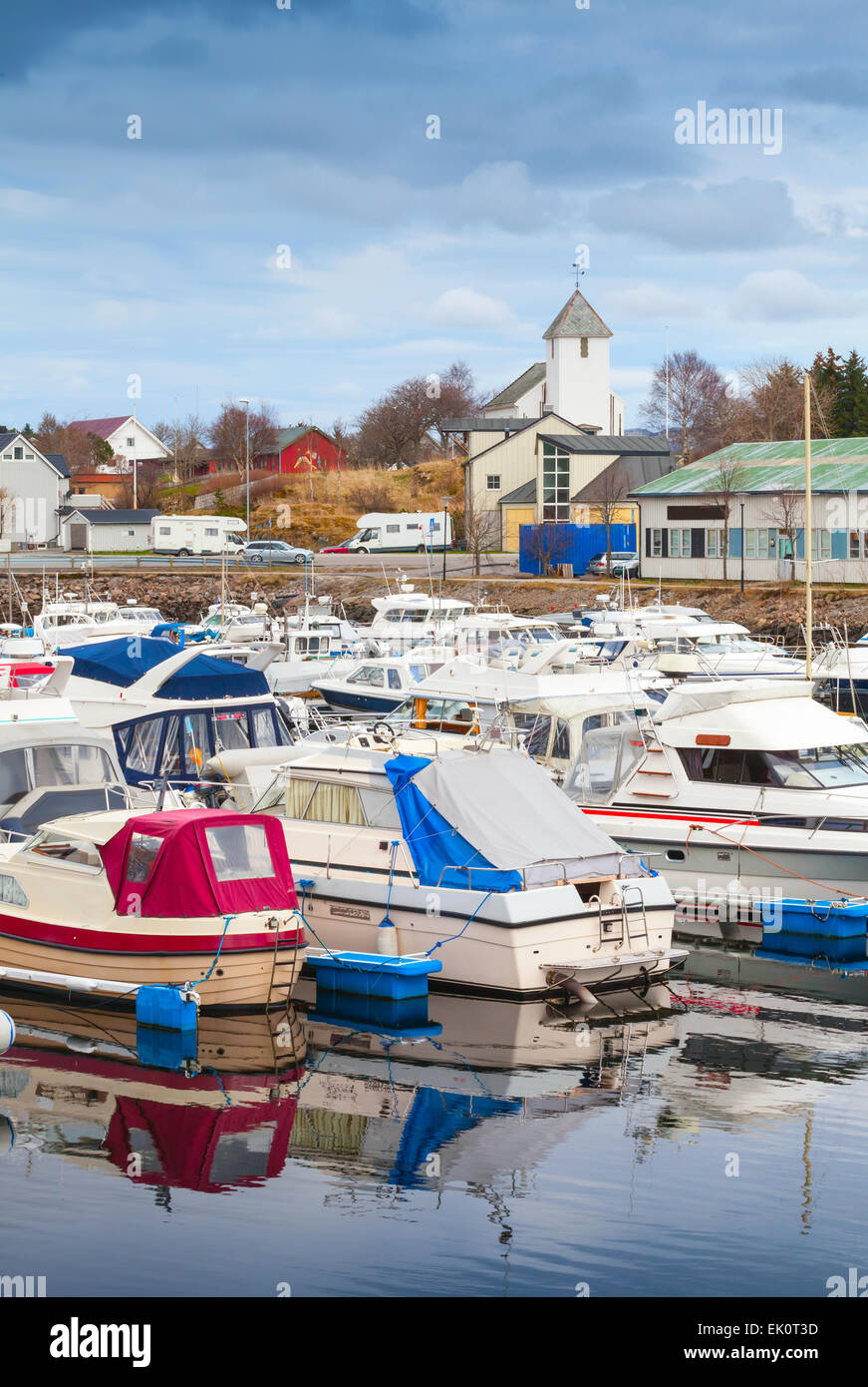 Typically Norwegian fishing village landscape. Small boats are moored in marina Stock Photo