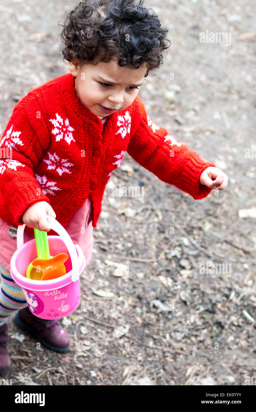High angle view of child carrying a toy. Stock Photo