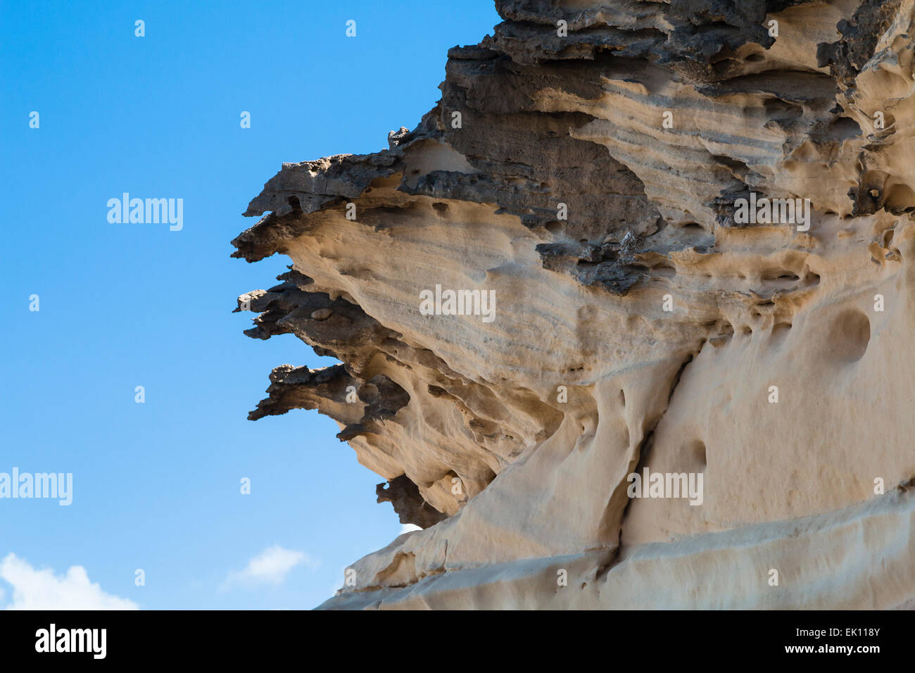 Eroding cliffs with holes in Jandia, Fuerteventura Stock Photo