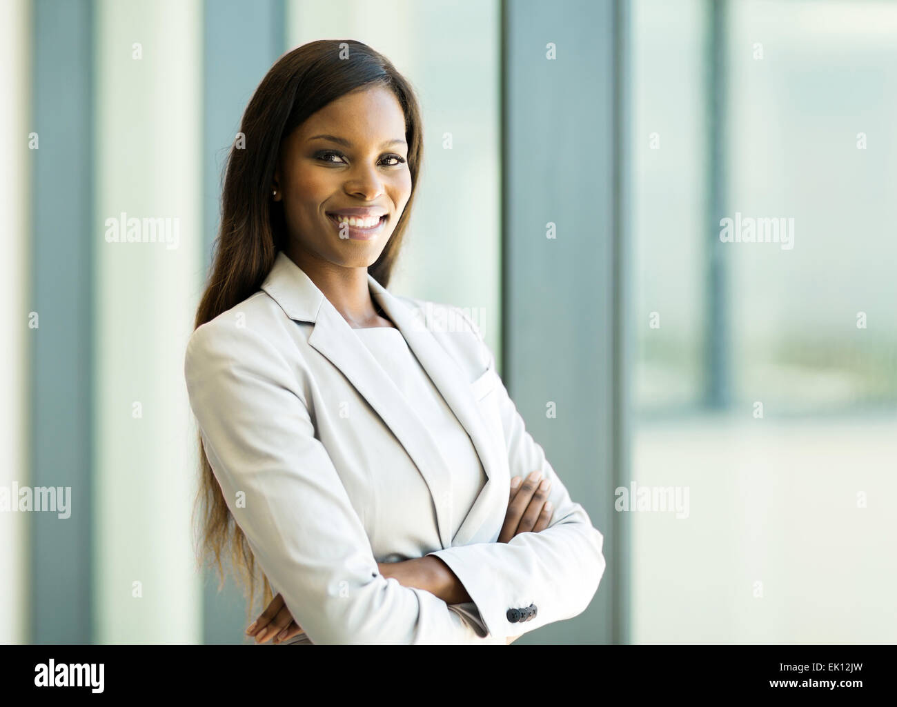 cute African American business woman with arms crossed in office Stock ...