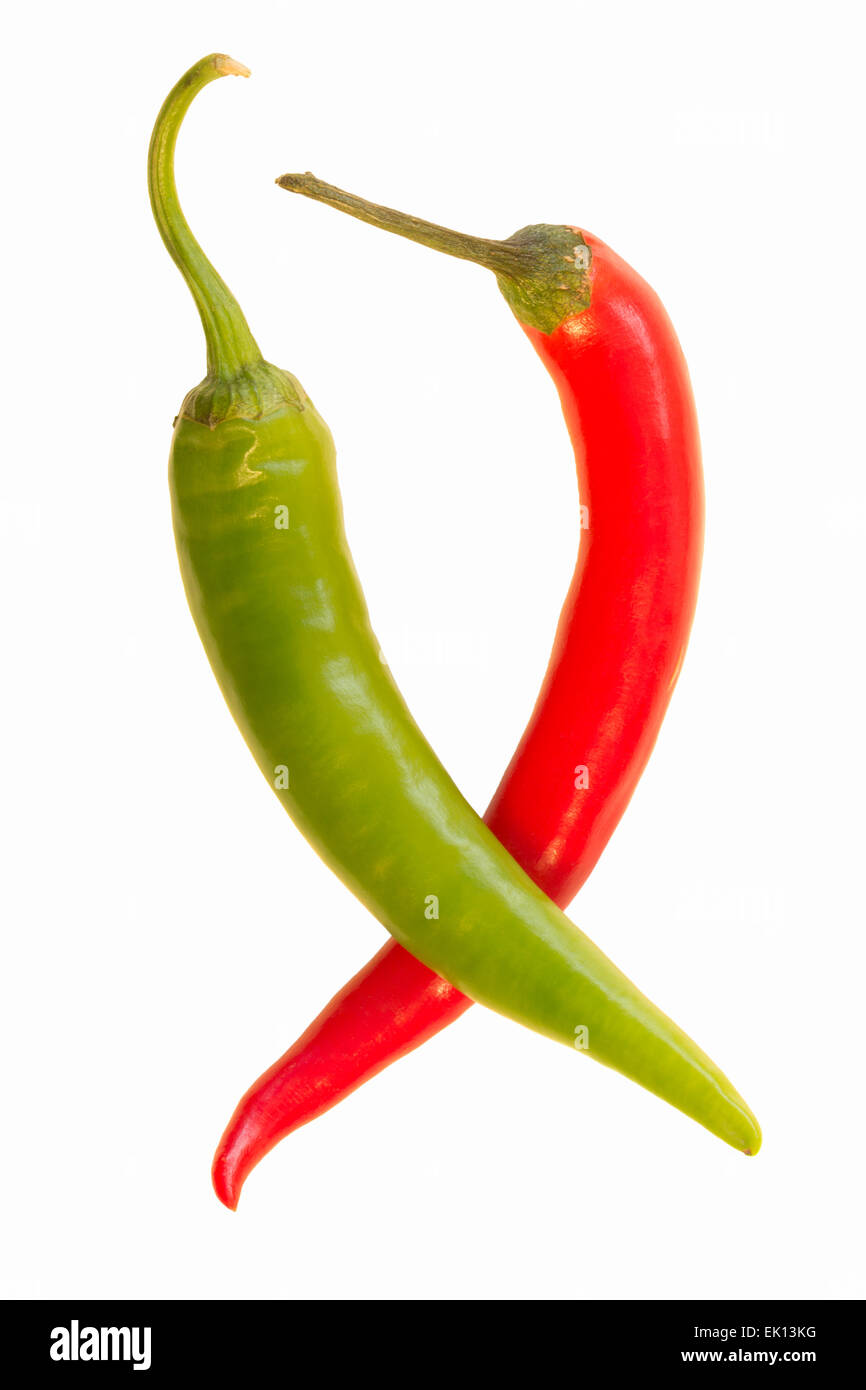 A whole green chili on top of a whole red chili (Capsicum annuum) isolated on white background Stock Photo