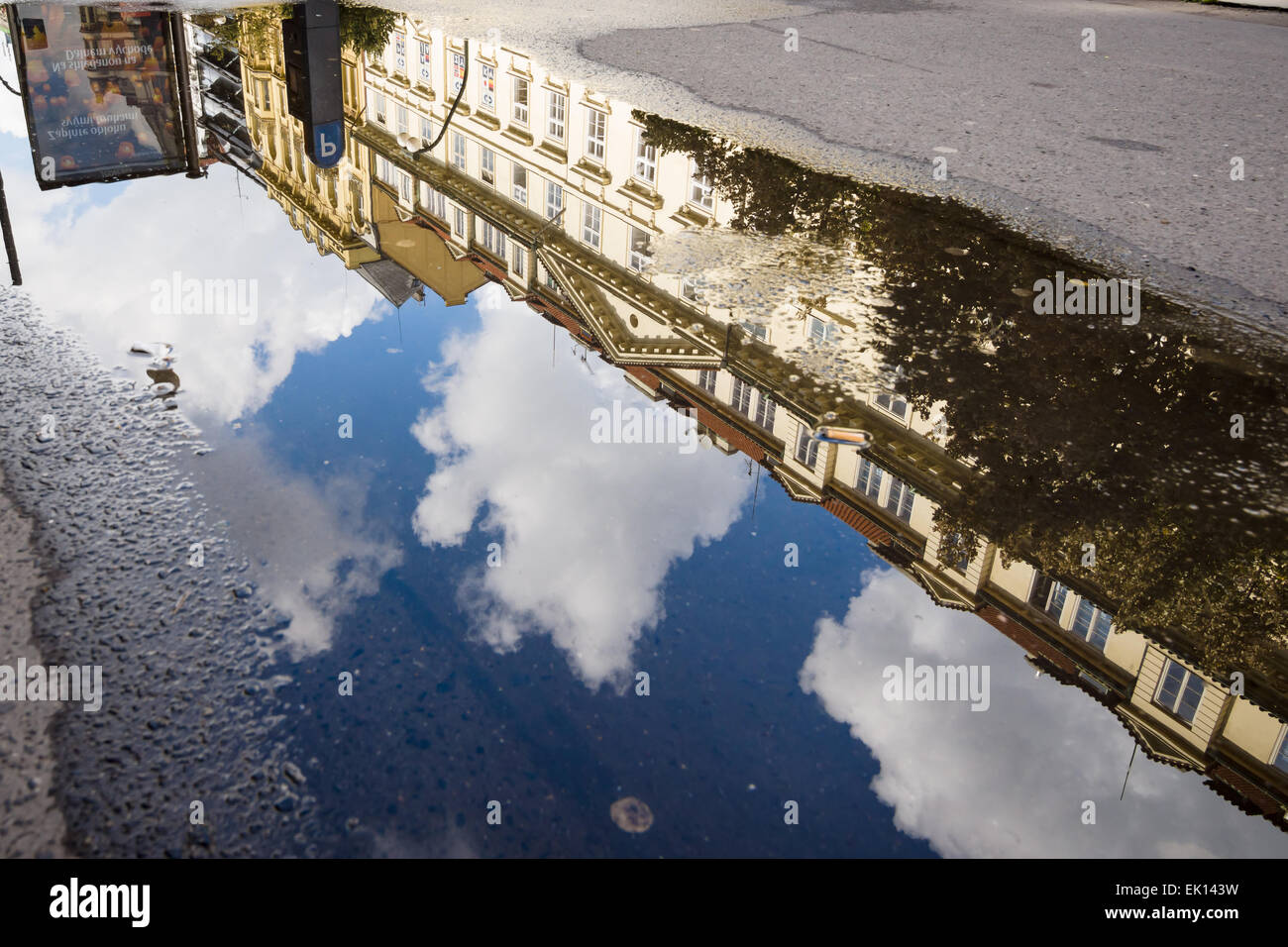 Reflections of old houses in a puddle after rain Stock Photo - Alamy