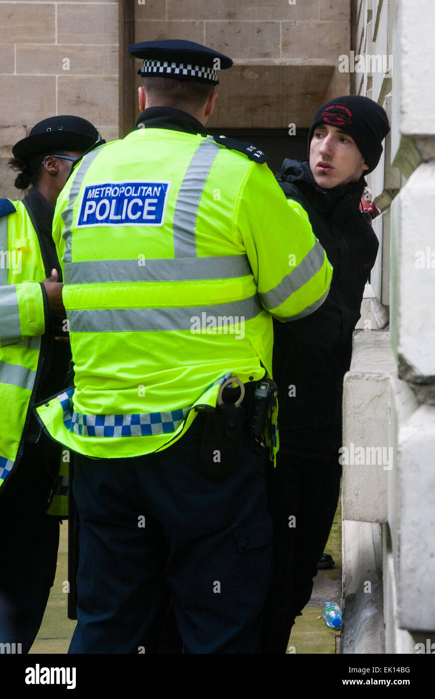 Whitehall, London, April 4th 2015. As PEGIDA UK holds a poorly attended rally on Whitehall, scores of police are called in to contain counter protesters from various London anti-fascist movements. PICTURED: A young anti-fascist is arrested after attempting to break through police lines into the PEGIDA enclosure. Credit:  Paul Davey/Alamy Live News Stock Photo