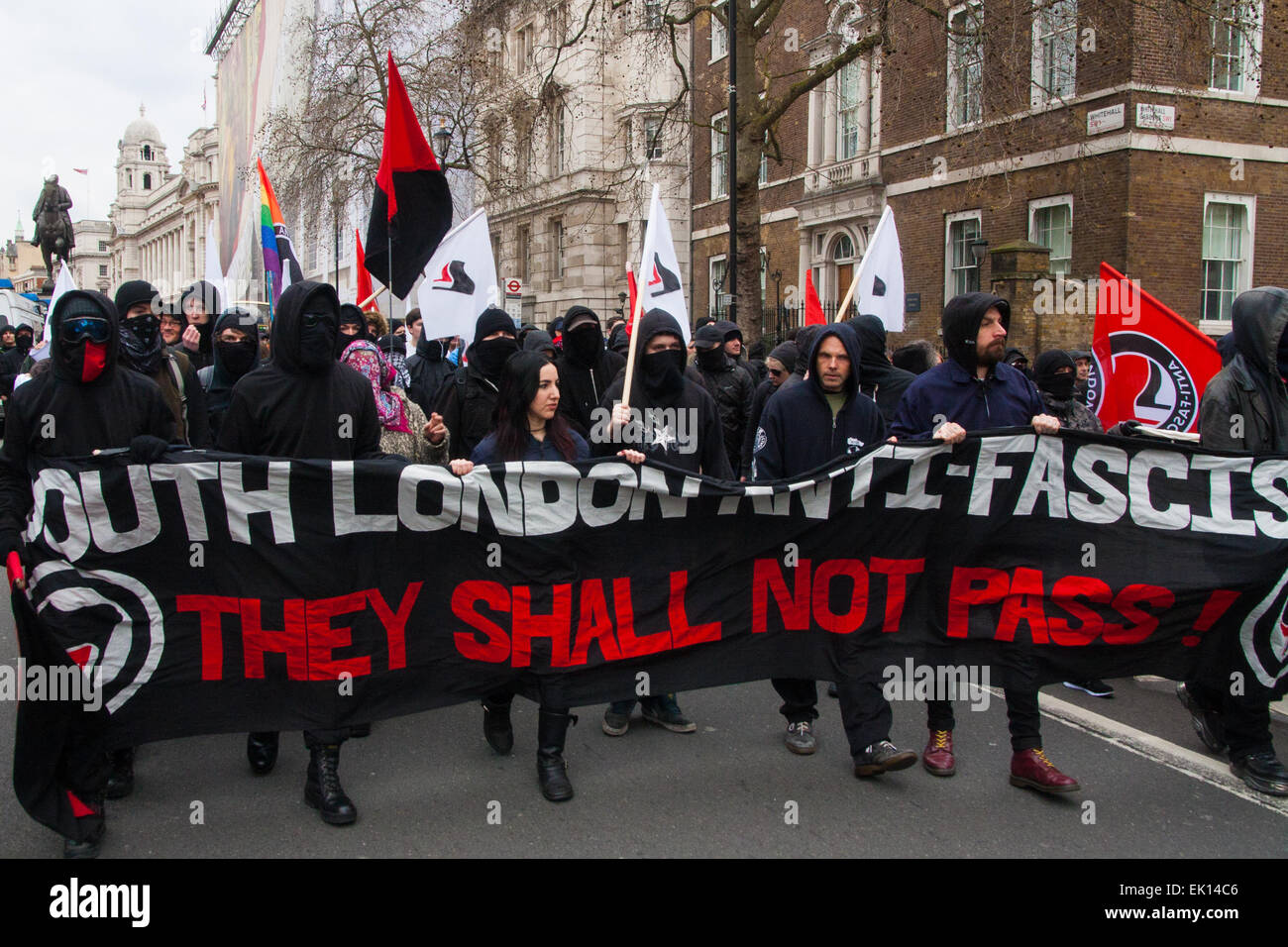 Whitehall, London, April 4th 2015. As PEGIDA UK holds a poorly attended rally on Whitehall, scores of police are called in to contain counter protesters from various London anti-fascist movements. PICTURED: Several dozen anti-fascists march down Whitehall as they counter-protest against PEGIDA. Credit:  Paul Davey/Alamy Live News Stock Photo