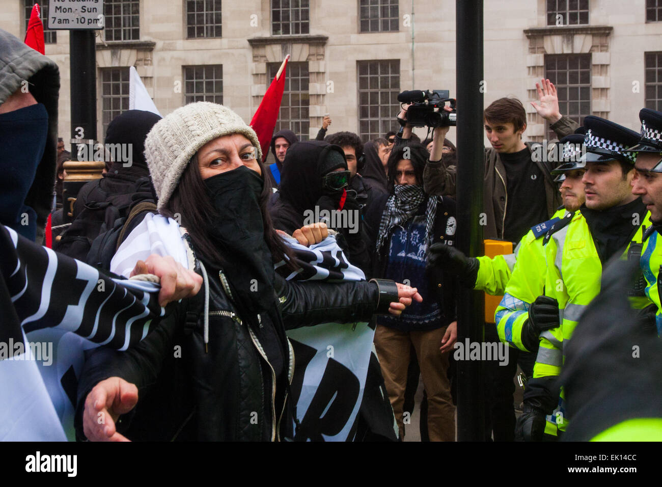 Whitehall, London, April 4th 2015. As PEGIDA UK holds a poorly attended rally on Whitehall, scores of police are called in to contain counter protesters from various London anti-fascist movements. PICTURED: Anti-fascists taunt the police during a stand-off after another failed attempt to reach the PEGIDA rally. Credit:  Paul Davey/Alamy Live News Stock Photo