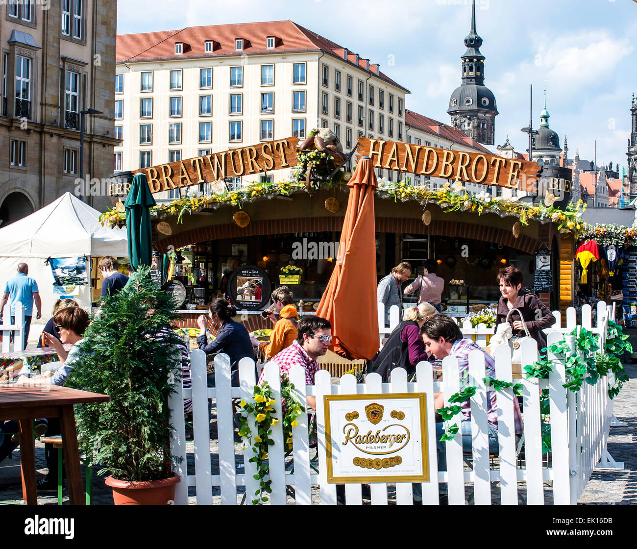 Eating sausages and drinking beer in a small outdoor cafe in Altmarkt, the old marketplace, in Dresden, Germany. Stock Photo