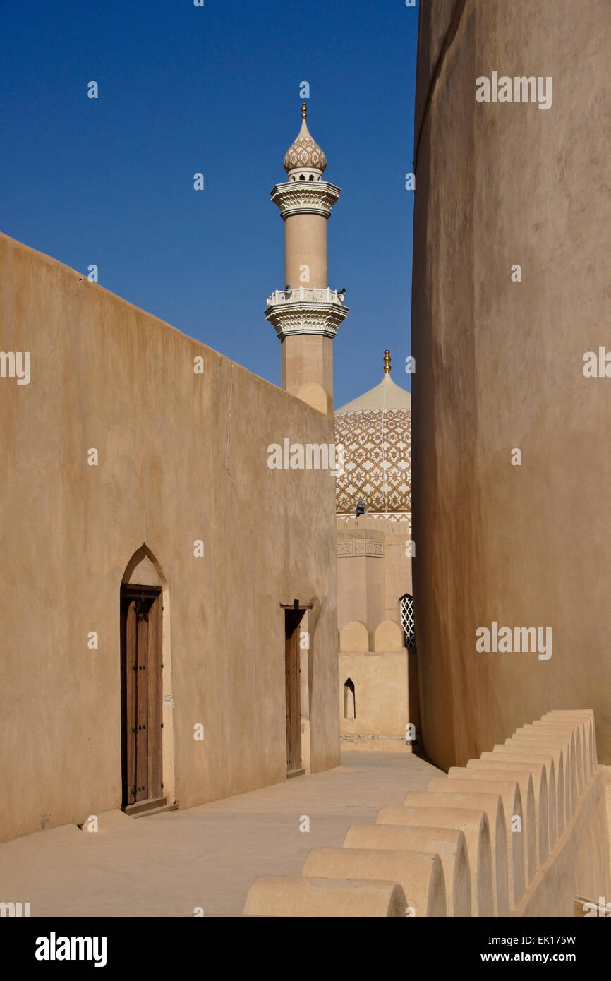 Nizwa Fort with mosque minaret and dome, Nizwa, Oman Stock Photo