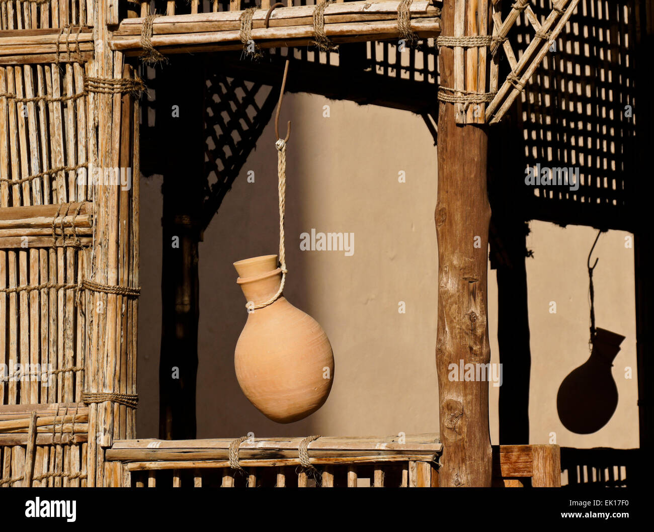 https://c8.alamy.com/comp/EK17F0/pottery-water-jug-hanging-in-window-of-latticed-wood-shelter-nizwa-EK17F0.jpg