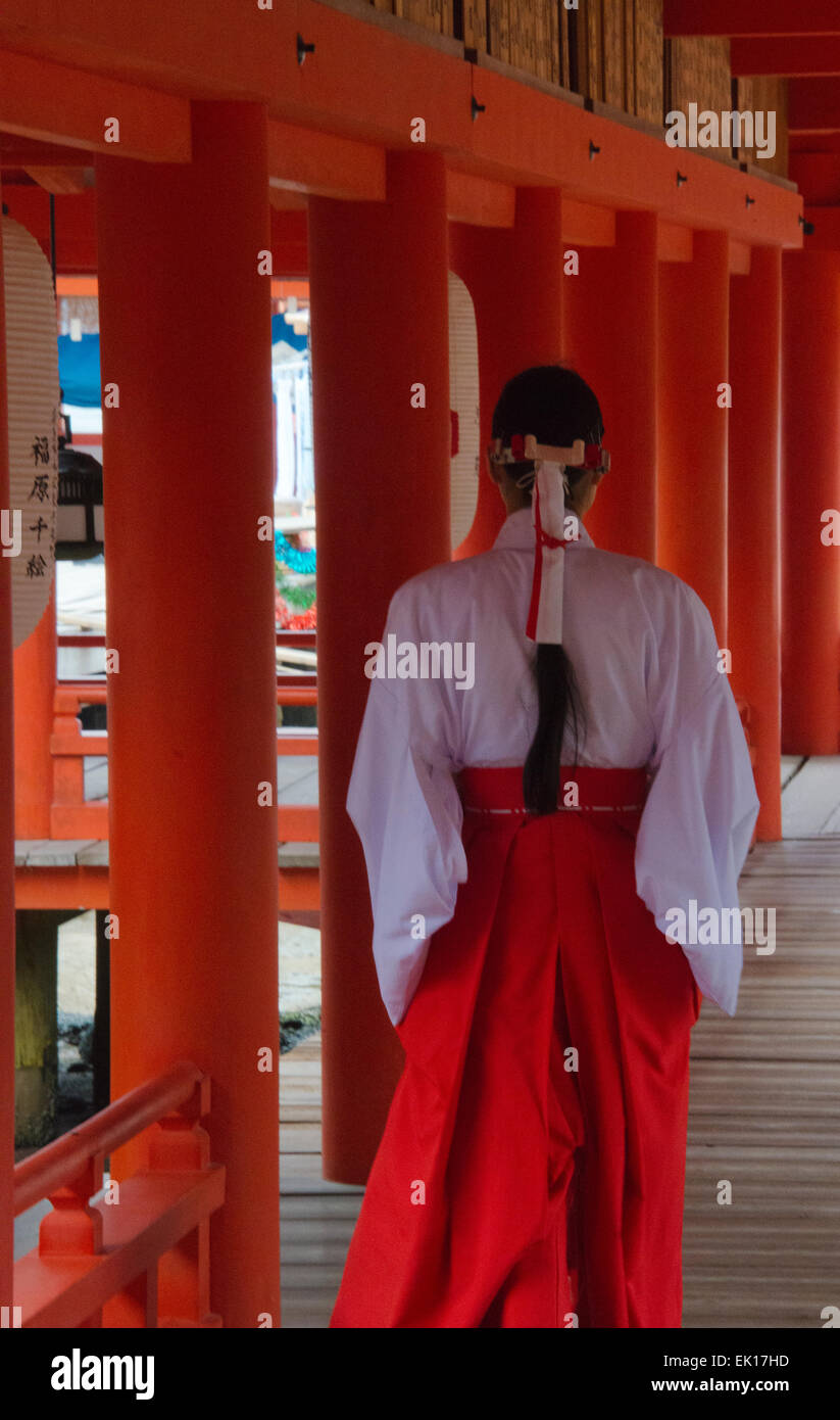 Temple server in traditional clothing at Itsukushima Shrine , Miyajima, Japan Stock Photo