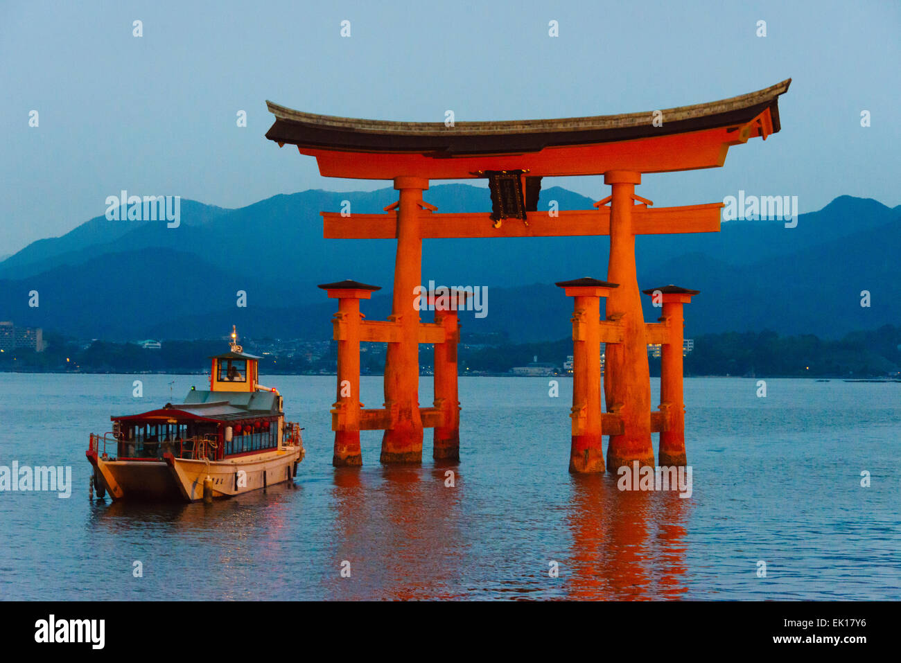 Boat approaching Torii Gate of Itsukushima Shrine during Kangen-sai Festival, Miyajima, Japan Stock Photo