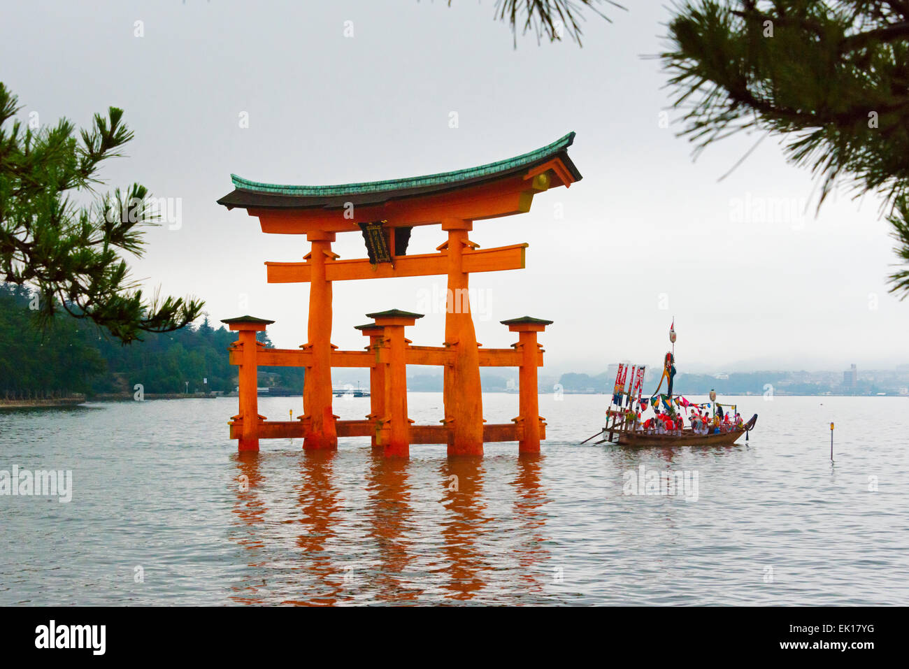 Boat approaching Torii Gate of Itsukushima Shrine during Kangen-sai Festival, Miyajima, Japan Stock Photo