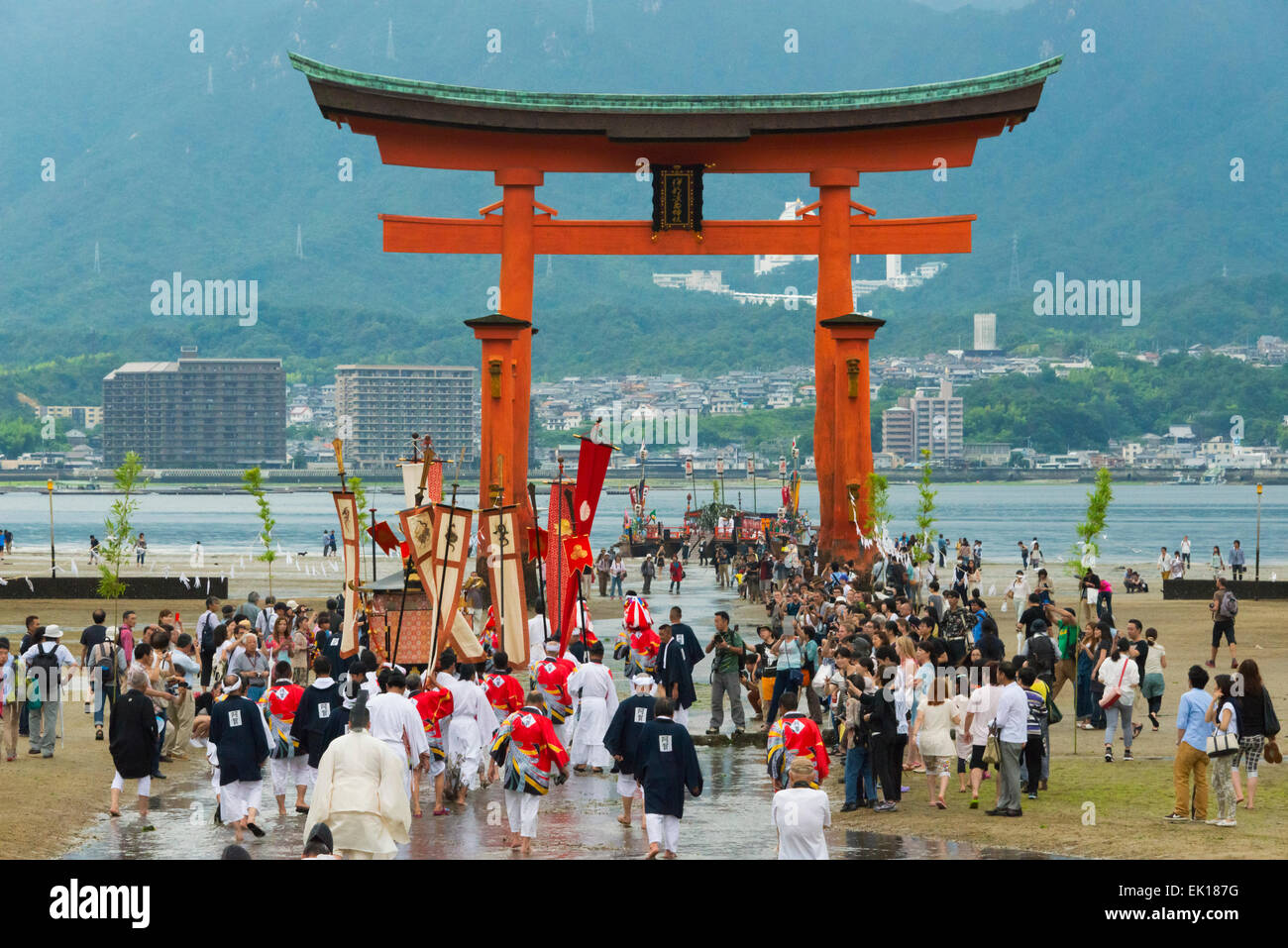 Priests at Torii Gate of Itsukushima Shrine during Kangen-sai Festival, Miyajima, Japan Stock Photo