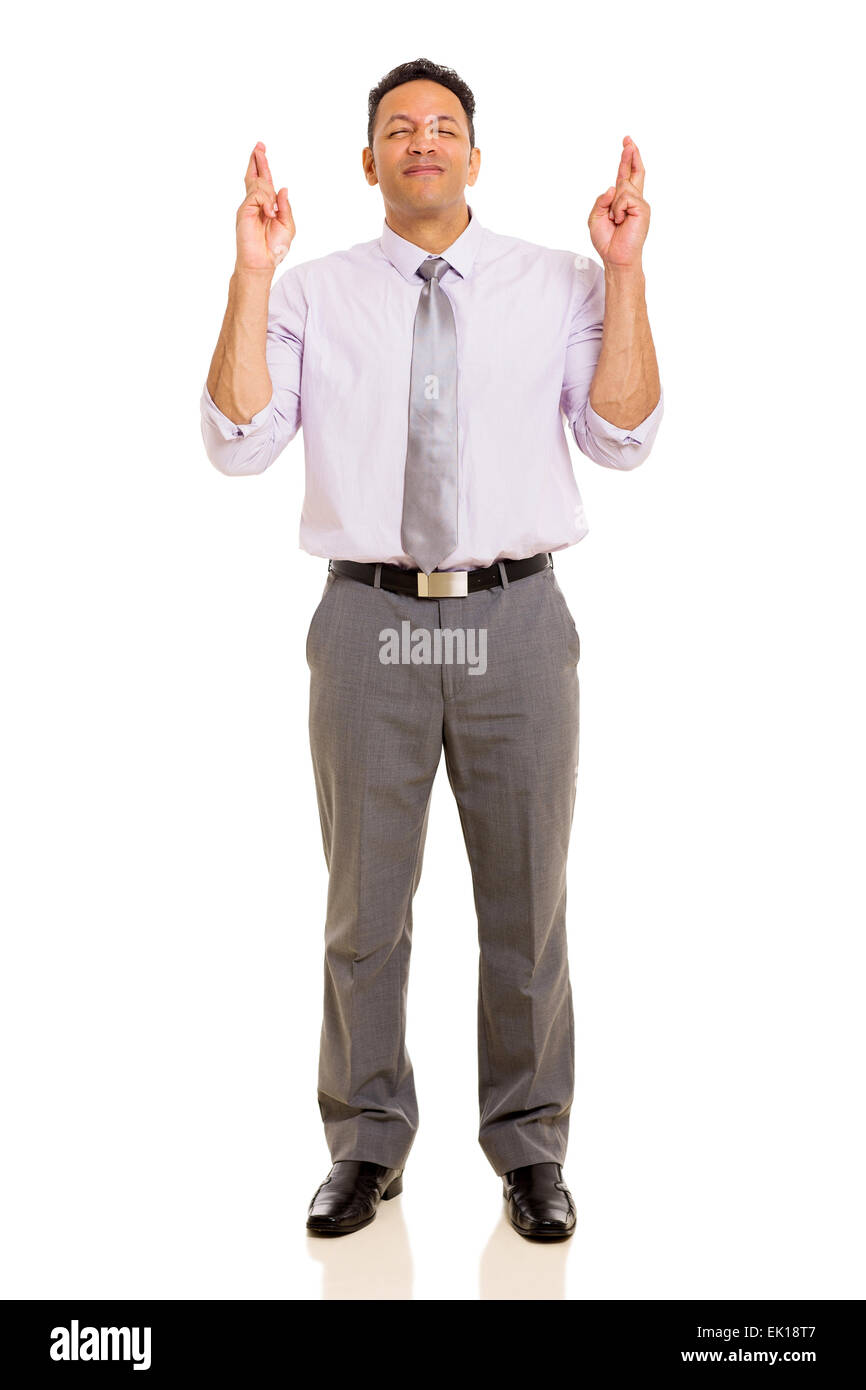 hopeful mid age man with fingers crossed isolated on white background Stock Photo