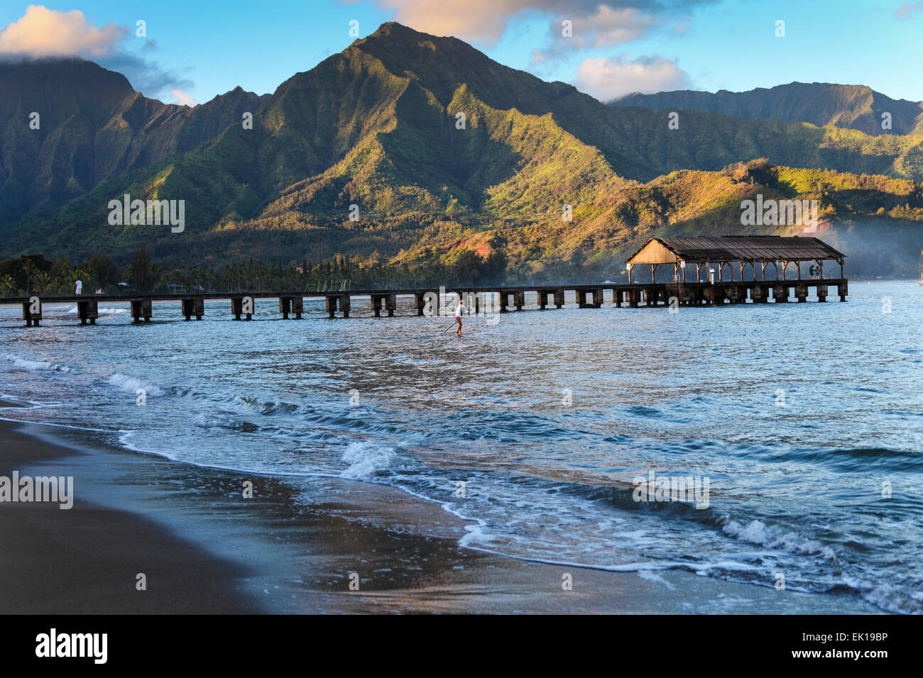 Stand up paddle boarder by Hanalei Pier at dawn Stock Photo