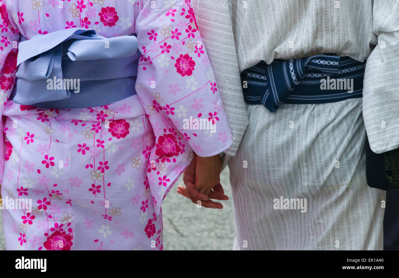 Women in traditional kimono holding hands together, Kyoto, Japan Stock Photo