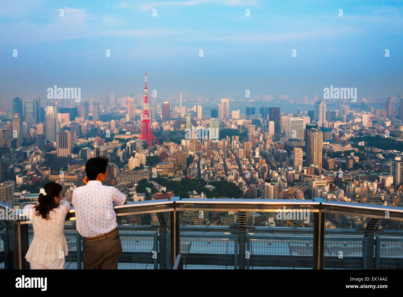 Tourists watching downtown skyline, Tokyo, Japan Stock Photo