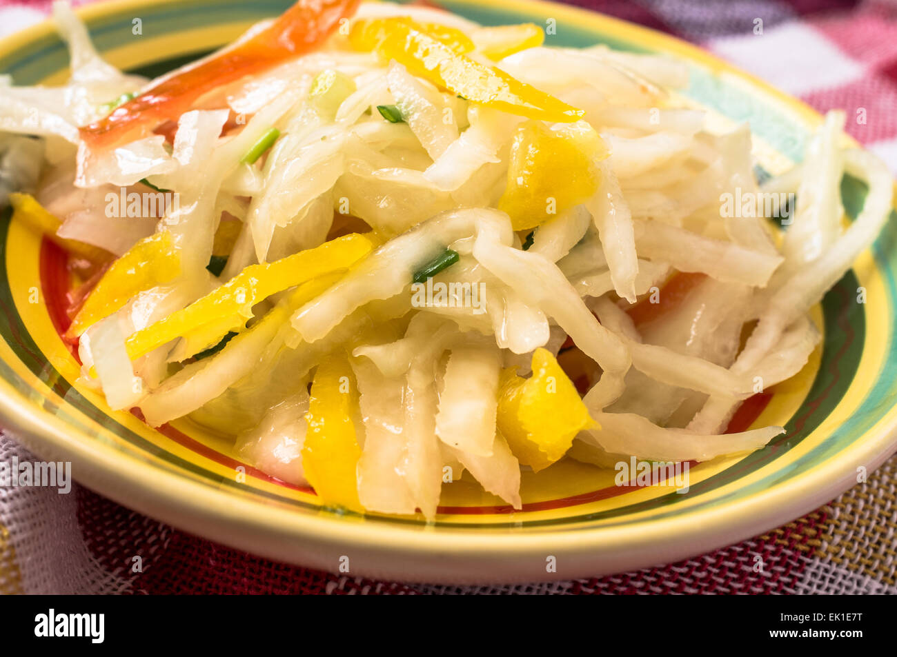 Salad with cabbage, yellow peppers and tomatoes in a bowl Stock Photo